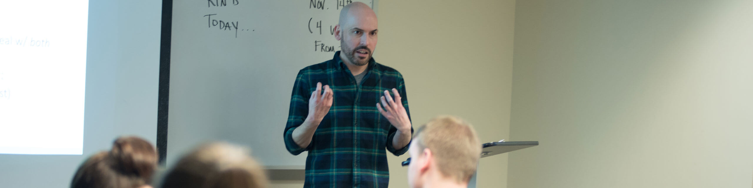 A professor teaches a classroom of students.