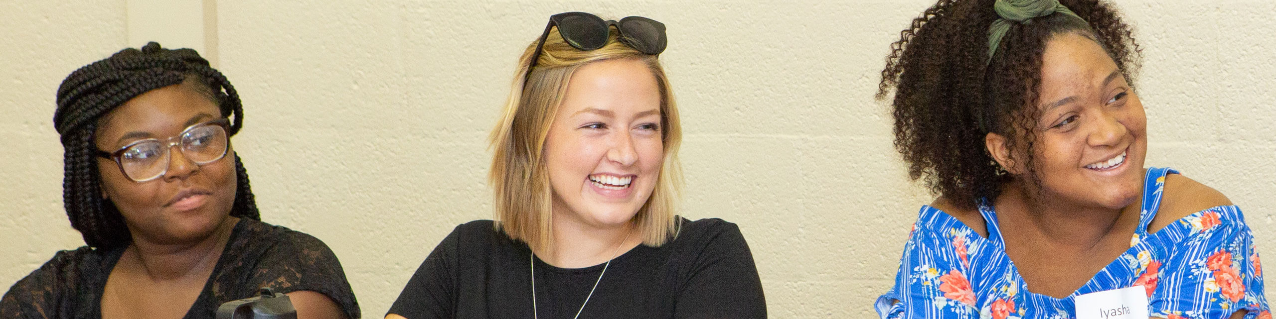 Students smile during a presentation.