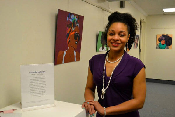 Student poses for a photo during her exhibition.