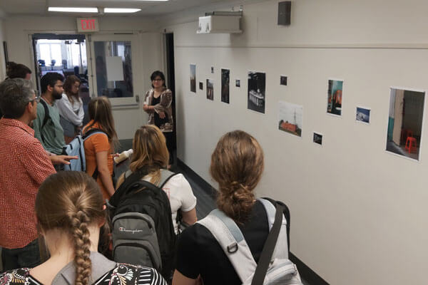 Students attend a exhibition opening.